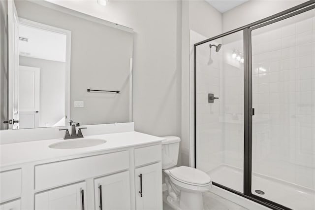 bathroom featuring vanity, toilet, and walk in shower