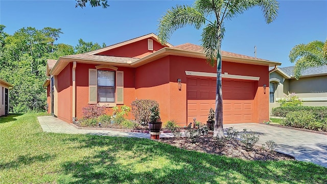 view of front of home with a front yard and a garage