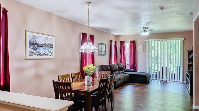 dining room with ceiling fan, a textured ceiling, and hardwood / wood-style flooring