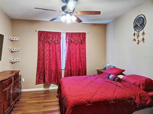 bedroom with ceiling fan and wood-type flooring