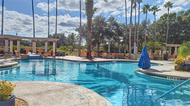 view of swimming pool featuring a pergola and a patio