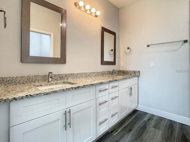 bathroom featuring dual vanity and hardwood / wood-style flooring