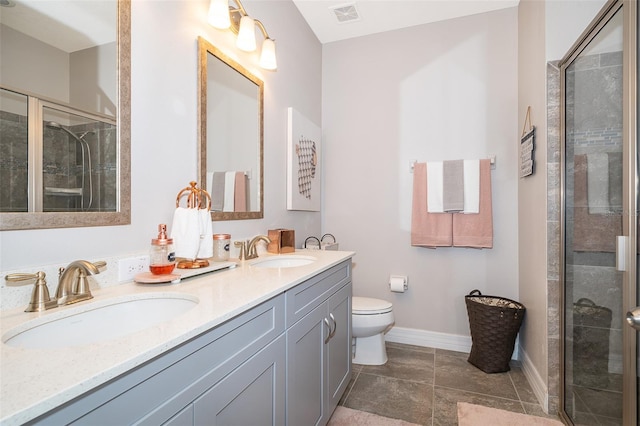 bathroom featuring vanity, toilet, and an enclosed shower