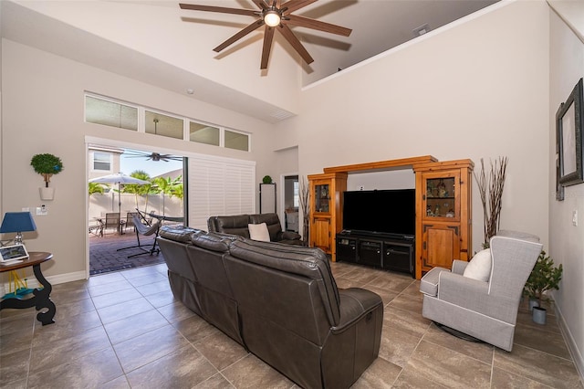 living room featuring a towering ceiling and ceiling fan