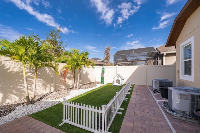 view of yard featuring a patio area and central air condition unit