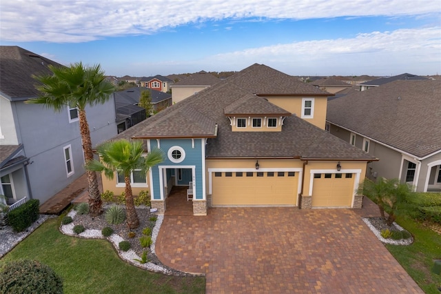 view of front of property featuring a garage and a front lawn