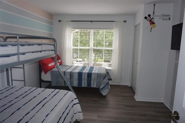 bedroom with dark hardwood / wood-style flooring