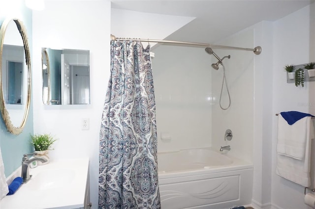 bathroom with shower / tub combo and vanity