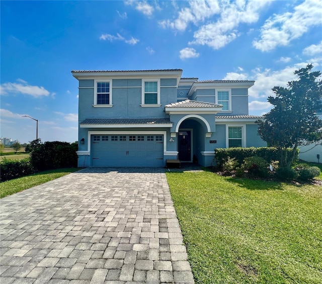 view of front of house featuring a front yard and a garage