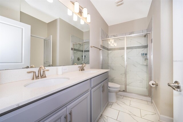 bathroom featuring vanity, toilet, and a shower with shower door