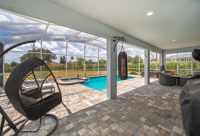 view of pool featuring glass enclosure, an in ground hot tub, a patio area, and grilling area