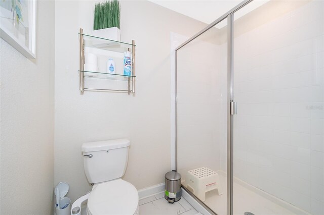 bathroom featuring an enclosed shower and toilet