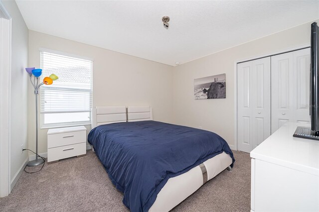 carpeted bedroom featuring a closet