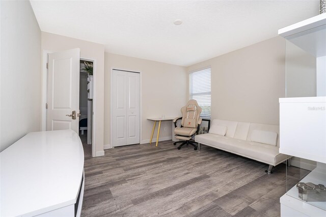 bedroom with a closet and dark wood-type flooring