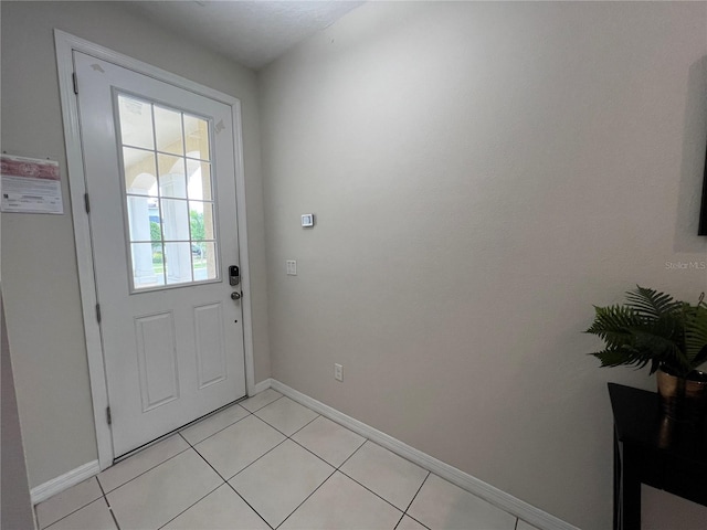 entryway with light tile patterned flooring