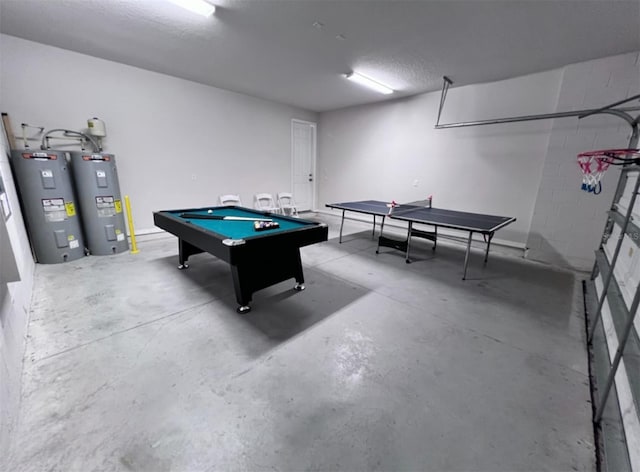 recreation room featuring electric water heater, concrete flooring, a textured ceiling, and pool table