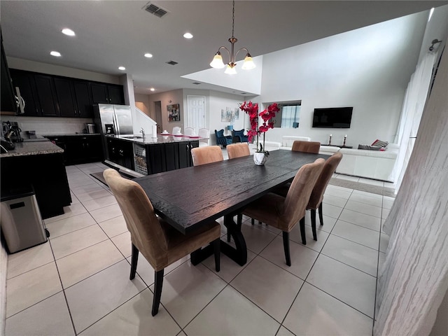 tiled dining room with a chandelier and sink