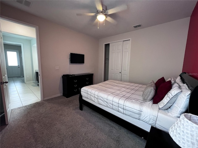 carpeted bedroom with ceiling fan and a closet