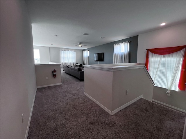 unfurnished living room with carpet flooring and ceiling fan