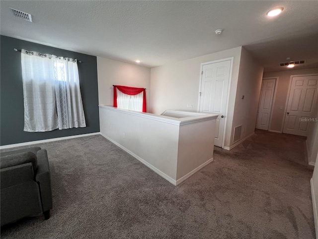 unfurnished bedroom with carpet floors and a textured ceiling