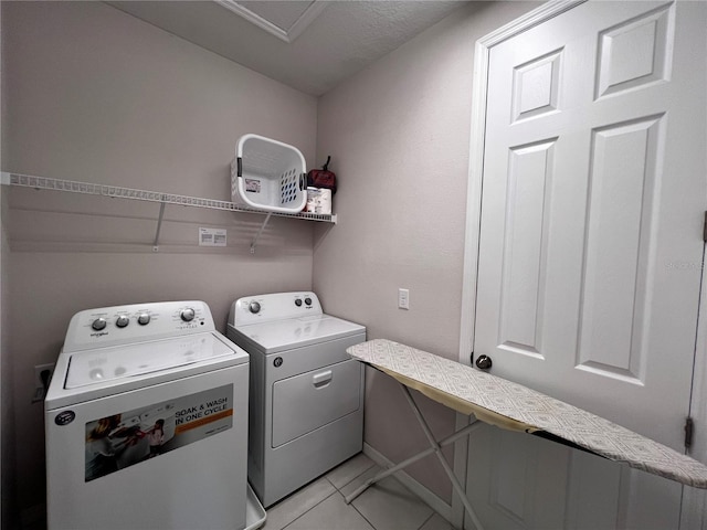 laundry area with light tile patterned floors and independent washer and dryer