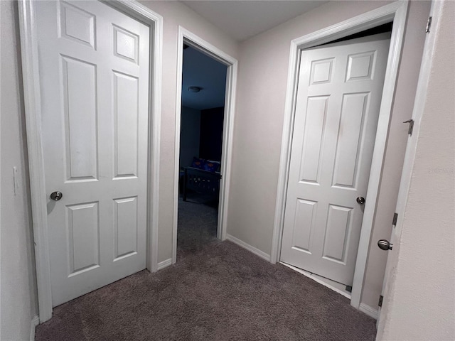 corridor with dark colored carpet