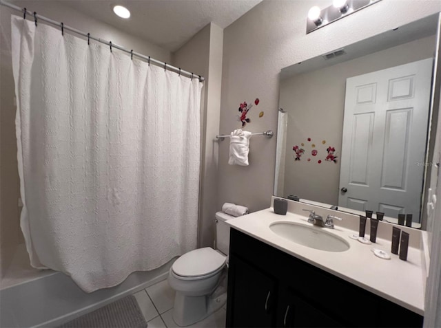 full bathroom with tile patterned floors, shower / bath combo with shower curtain, vanity, and toilet