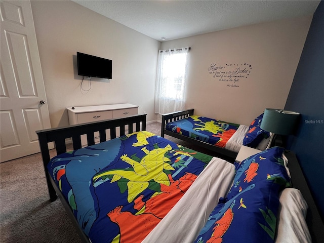 bedroom featuring a textured ceiling and carpet floors