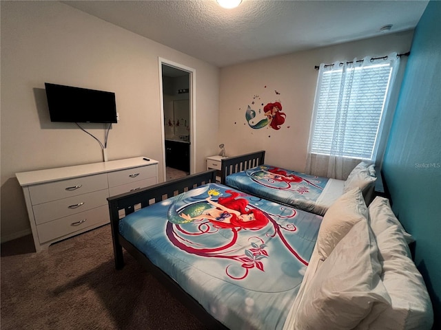 bedroom featuring carpet floors, a textured ceiling, and connected bathroom