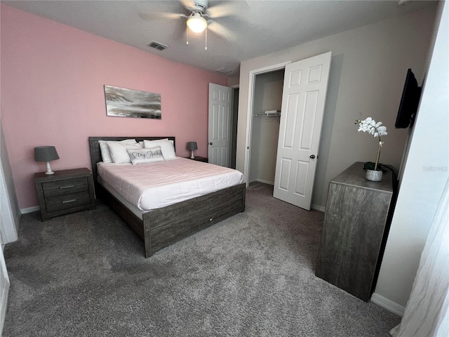 carpeted bedroom with a walk in closet, ceiling fan, and a closet