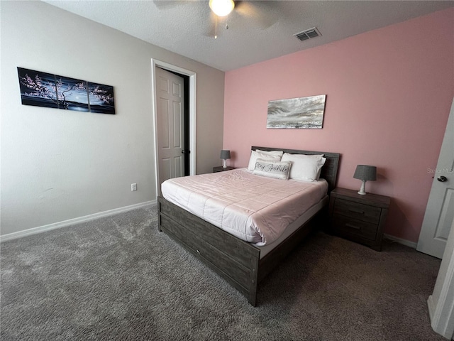 carpeted bedroom with ceiling fan and a textured ceiling