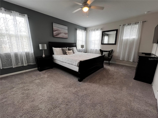 carpeted bedroom featuring ceiling fan and multiple windows