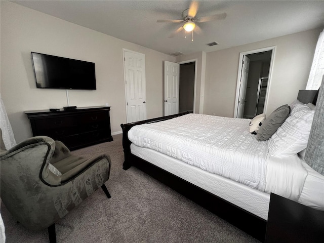 bedroom with carpet flooring, ceiling fan, and ensuite bathroom