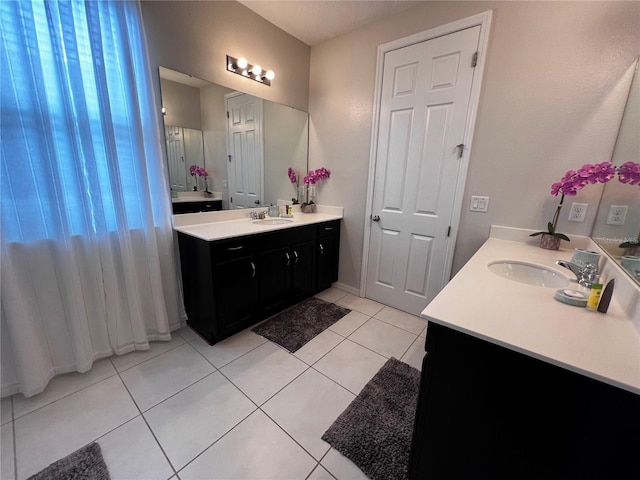 bathroom featuring tile patterned flooring and vanity