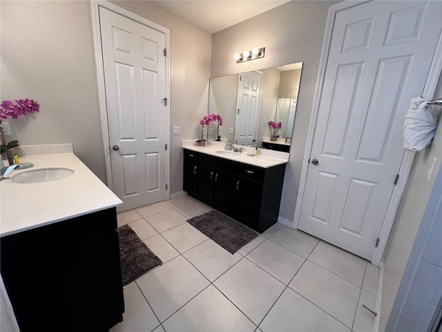 bathroom with tile patterned flooring and vanity