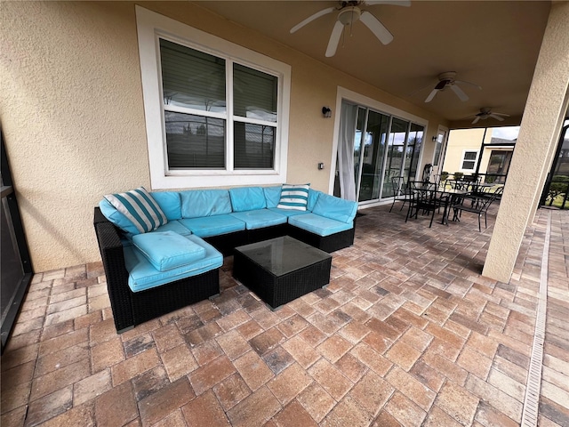 view of patio with an outdoor living space and ceiling fan