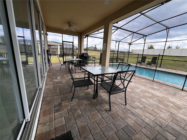 unfurnished sunroom featuring ceiling fan and a swimming pool