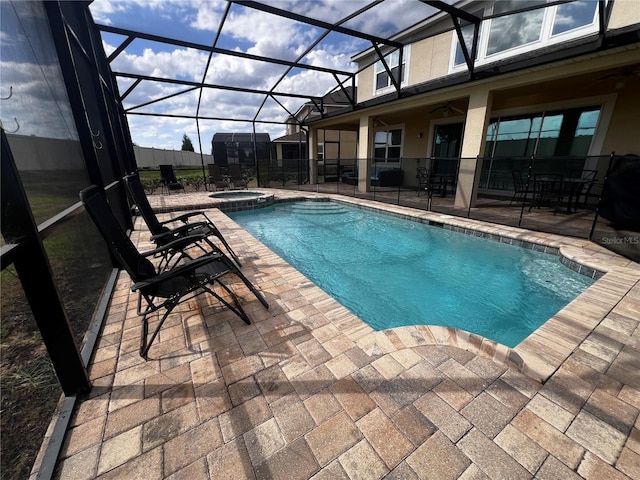 view of pool with a lanai, an in ground hot tub, and a patio