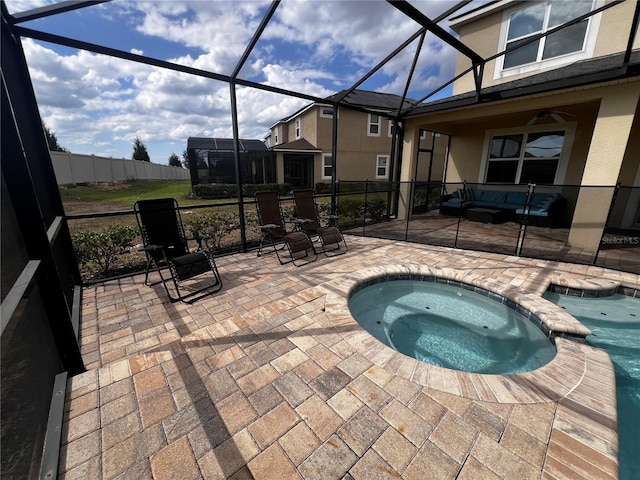 view of swimming pool with outdoor lounge area, a lanai, an in ground hot tub, and a patio