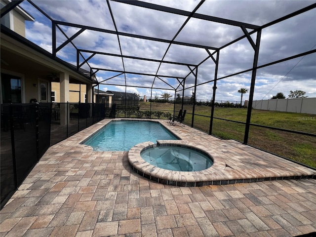 view of pool featuring an in ground hot tub, a patio, glass enclosure, and a lawn