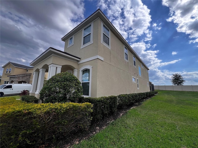 view of property exterior featuring a lawn