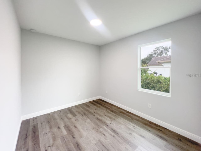 empty room with hardwood / wood-style flooring