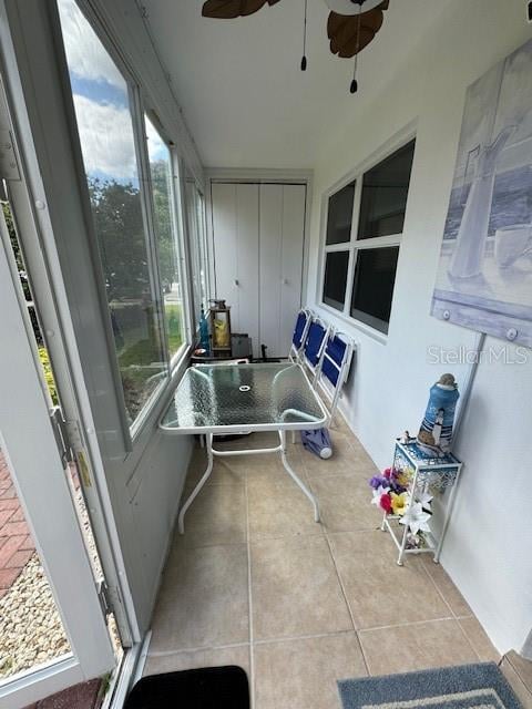 sunroom / solarium with a healthy amount of sunlight and ceiling fan