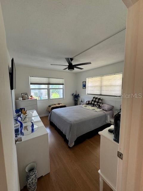 bedroom featuring dark hardwood / wood-style flooring and ceiling fan