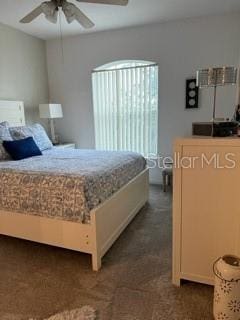 bedroom featuring dark colored carpet and ceiling fan