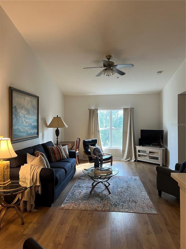 living room featuring hardwood / wood-style flooring and ceiling fan