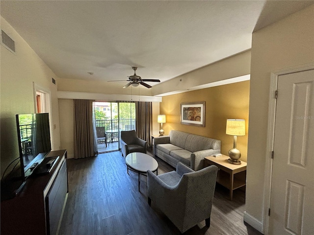 living room with ceiling fan and dark hardwood / wood-style flooring