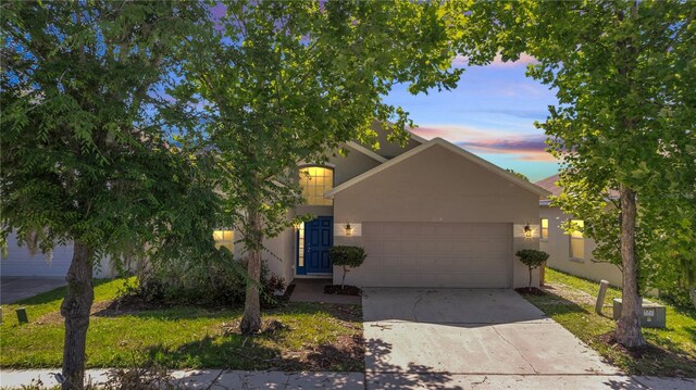 view of property hidden behind natural elements featuring a garage