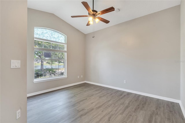 spare room featuring lofted ceiling, ceiling fan, and wood-type flooring