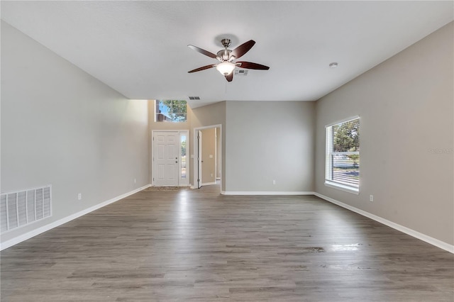 unfurnished living room with hardwood / wood-style floors and ceiling fan